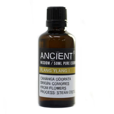 A 50ml amber glass bottle of ylang ylang essential oil with a black ribbed cap and allergen declarations from comores