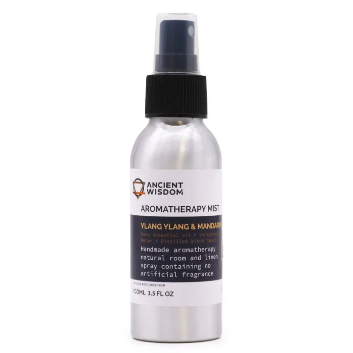 A sleek silver spray bottle with black nozzle labeled ancient wisdom aromatherapy mist ylang ylang essential and mandarin essential oil